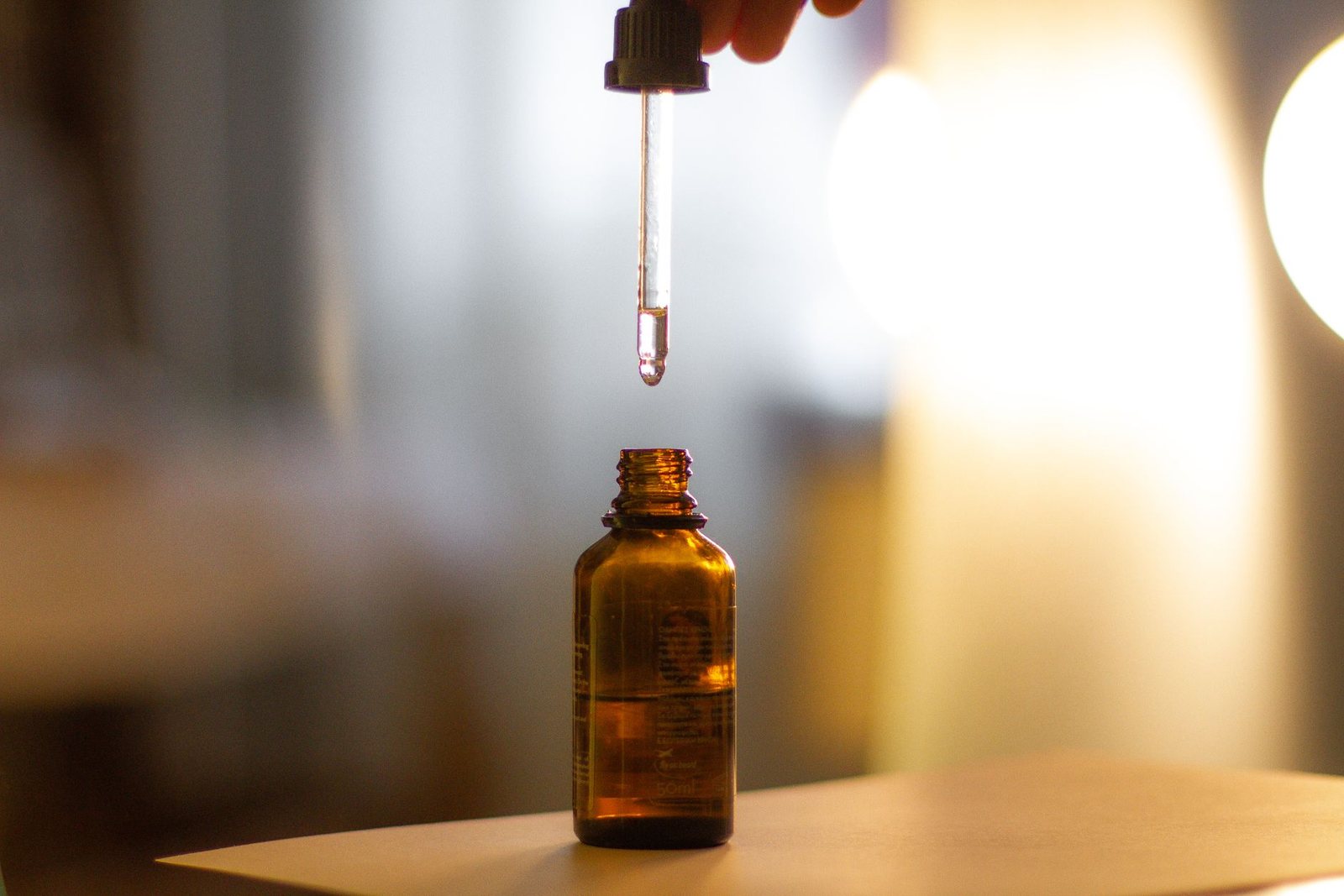 Serum dropper and bottle in warm light, a skin-quality treatment at Opulence Aesthetics